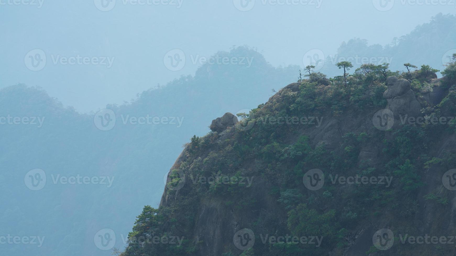 The beautiful mountains landscapes with the green forest and the erupted rock cliff as background in the countryside of the China photo