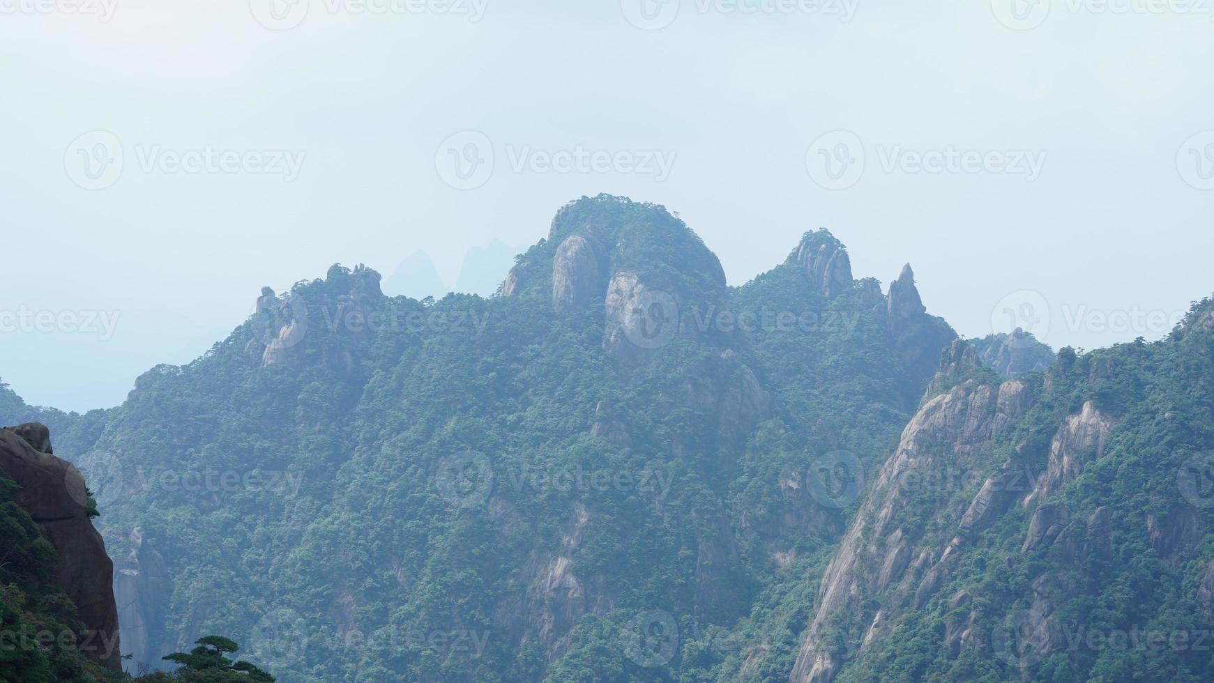 The beautiful mountains landscapes with the green forest and the erupted rock cliff as background in the countryside of the China photo