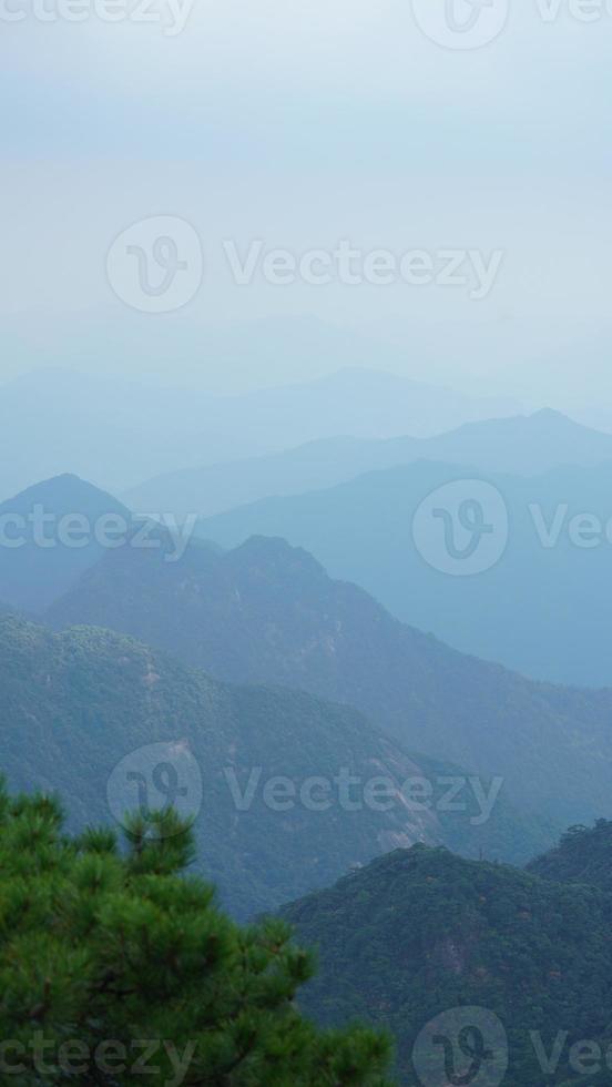 The beautiful mountains landscapes with the green forest and the erupted rock cliff as background in the countryside of the China photo