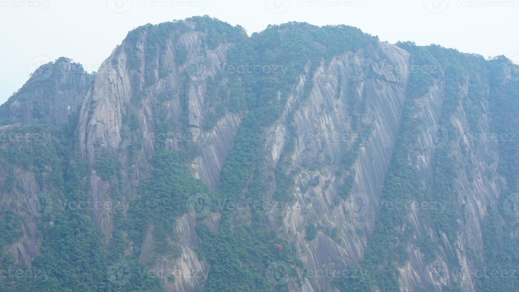 The beautiful mountains landscapes with the green forest and erupted rock cliff as background in the countryside of the China photo