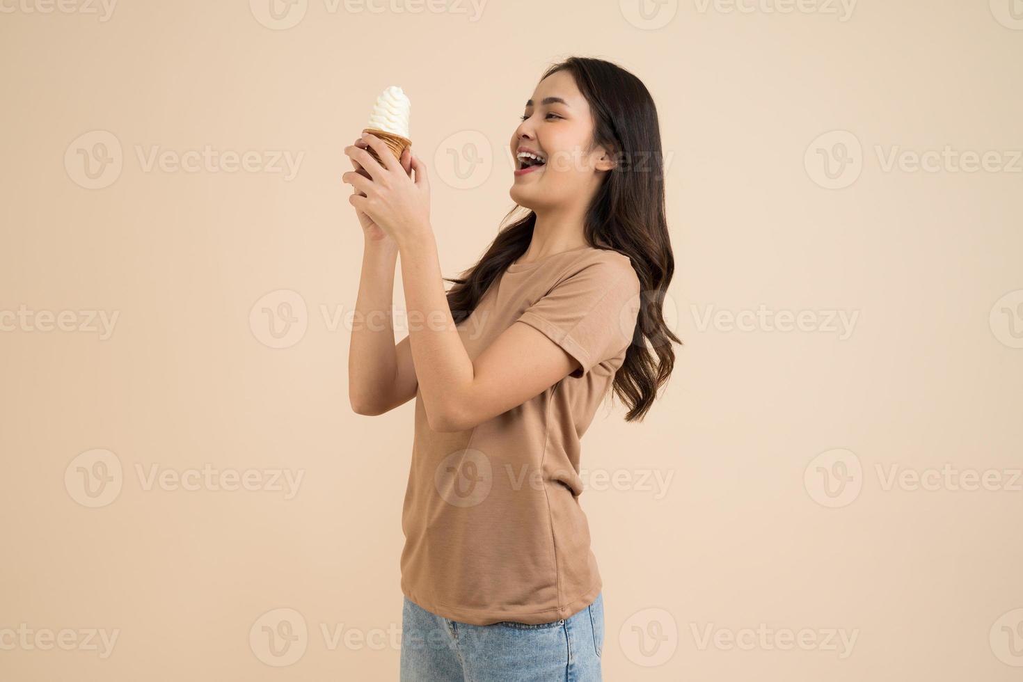 Happy young woman eating ice cream photo