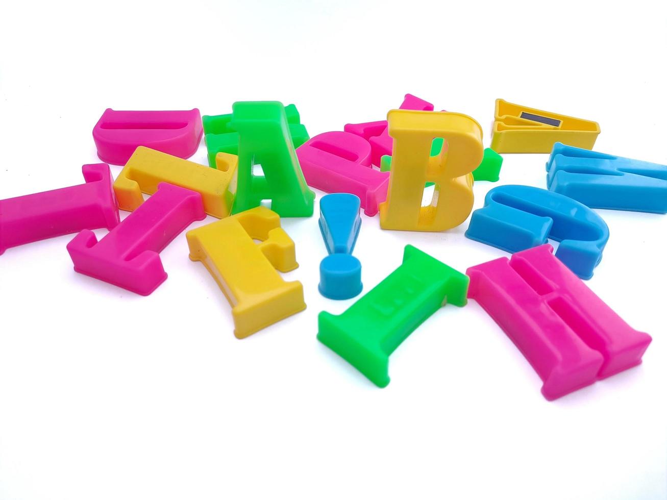 Close up of colorful alphabets on white background perfect for children's education photo