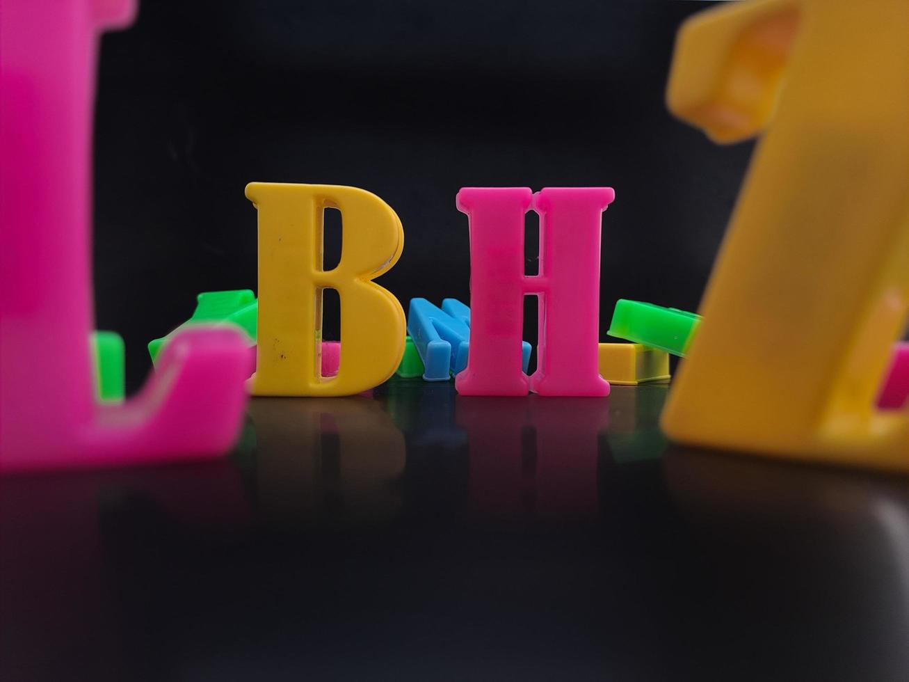 Close up of colorful alphabets on black background perfect for children's education photo