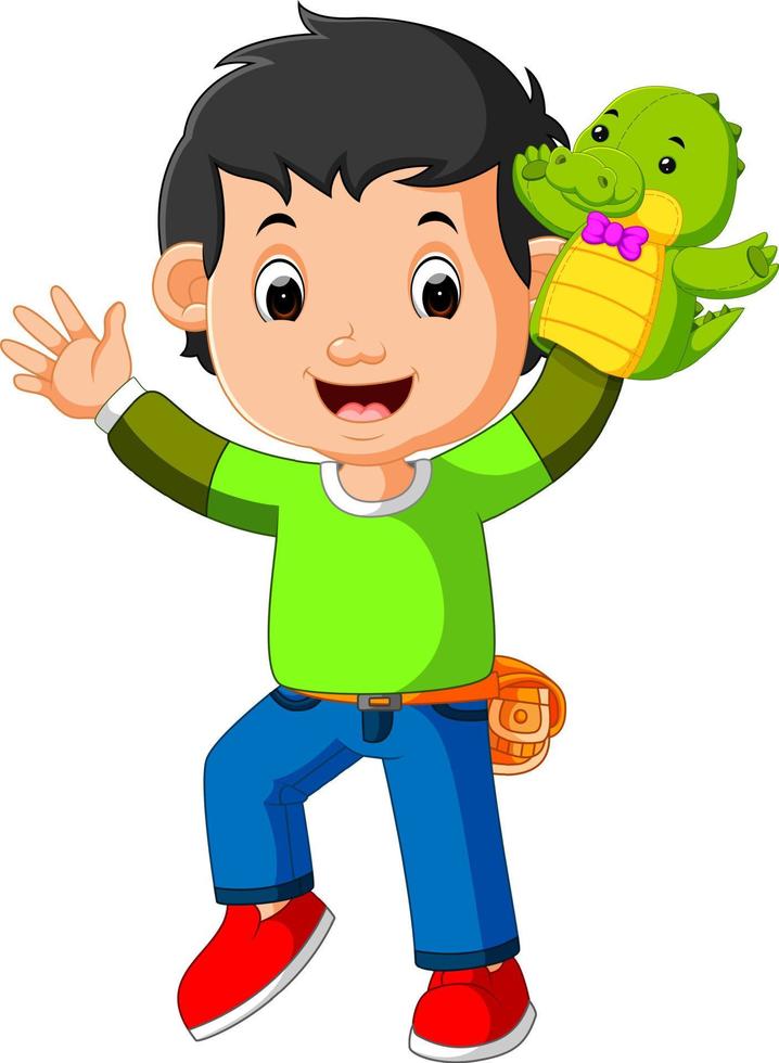 the happy boy was using crocodile puppet vector