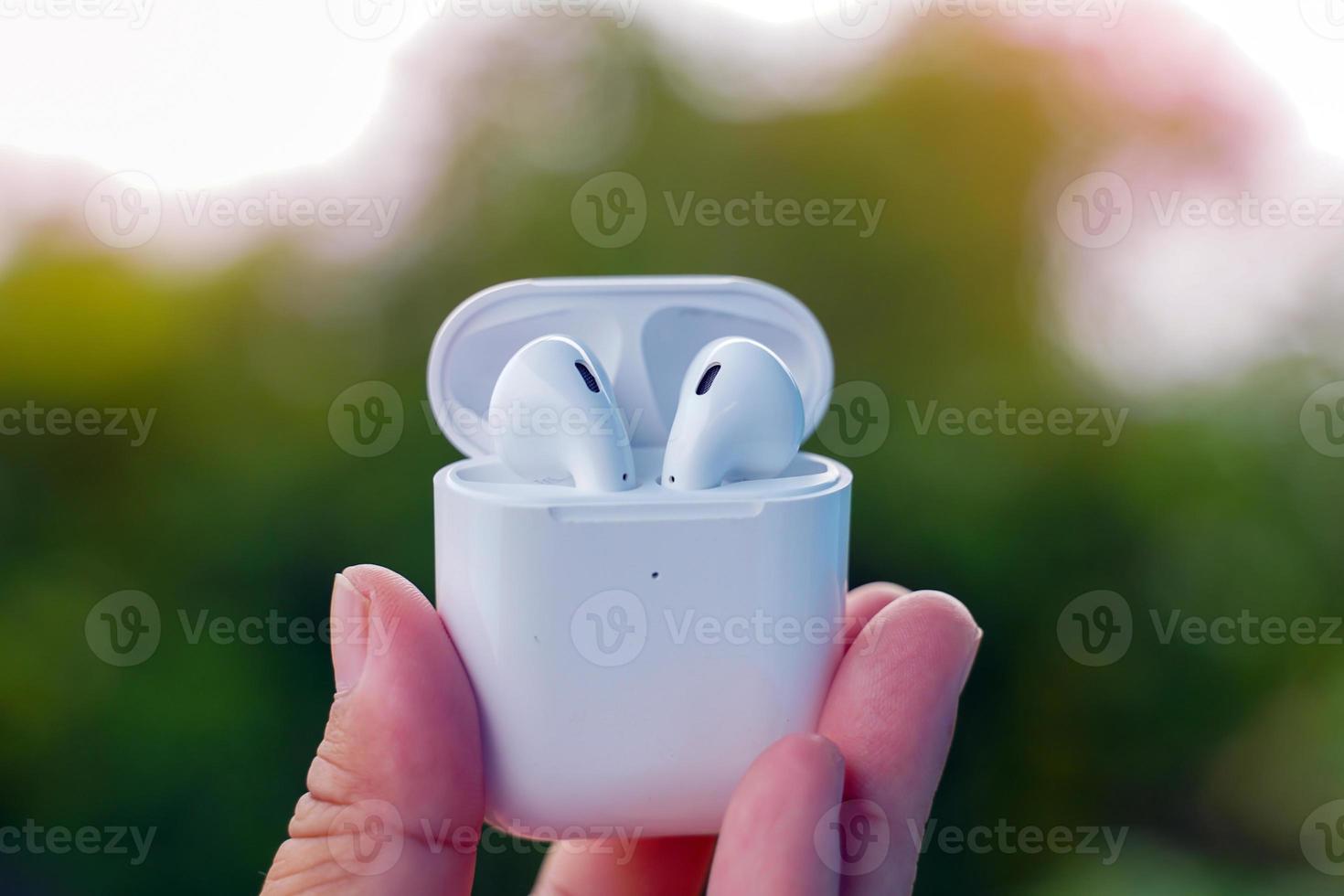 wireless Bluetooth headphones holding in hand photo