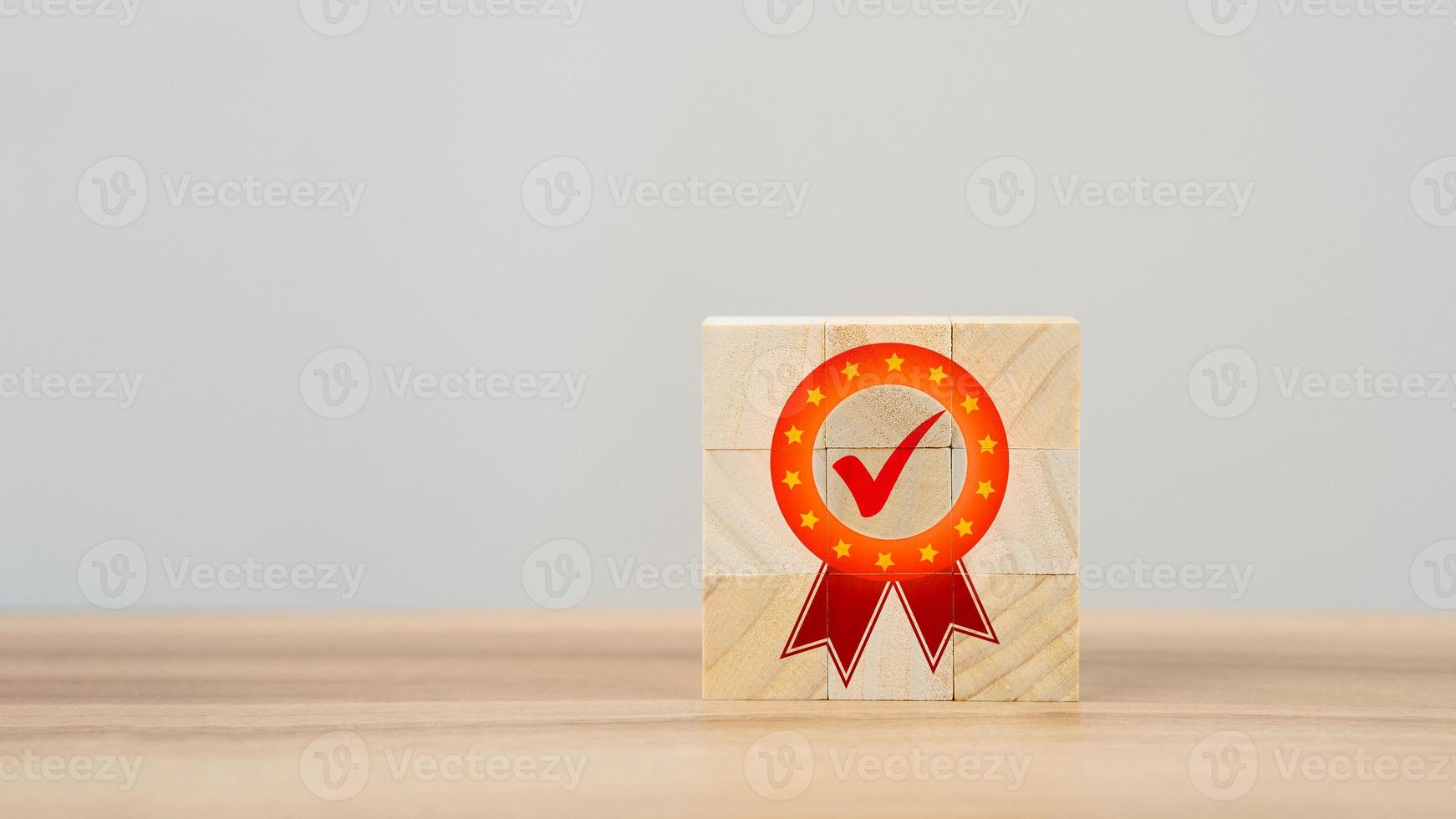 Quality guarantee sign on wooden cube on table. Service quality assurance, Standards, ISO certification and standardization concept. Advertising product and quality commitment. photo