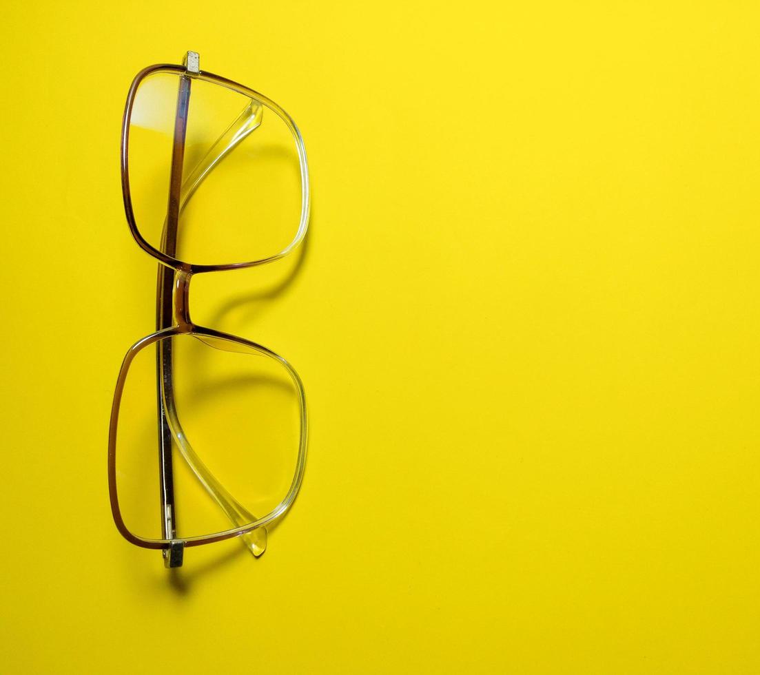 clear glasses on a yellow background  copy space photo