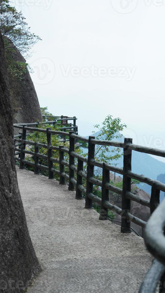 The beautiful mountains landscapes with the green forest and a plank road built along the face of a cliff in the countryside of the China photo