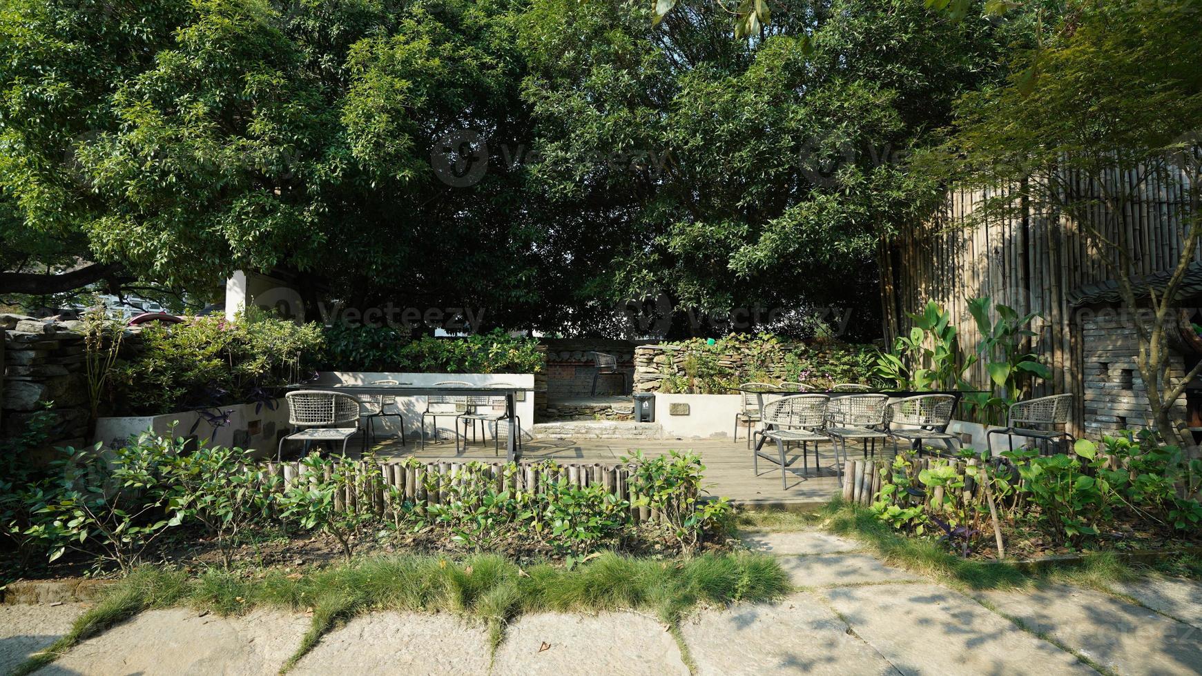 The beautiful garden view with the flowers and stone tables in the countryside village of the China photo