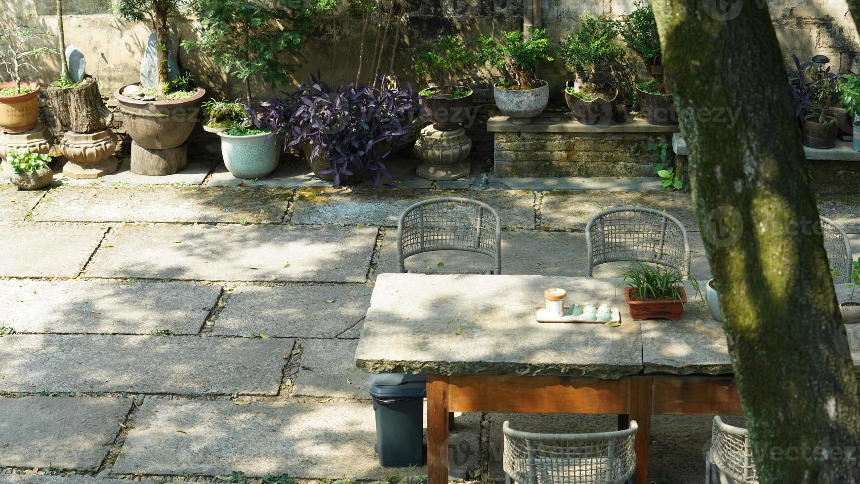 The beautiful garden view with the flowers and stone tables in the countryside village of the China photo