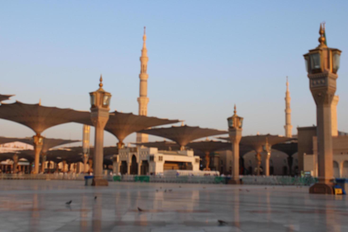 Medina, Saudi Arabia, Oct 2022 - A beautiful daytime view of Masjid Al Nabawi minarets and electronic umbrellas or canopies. photo