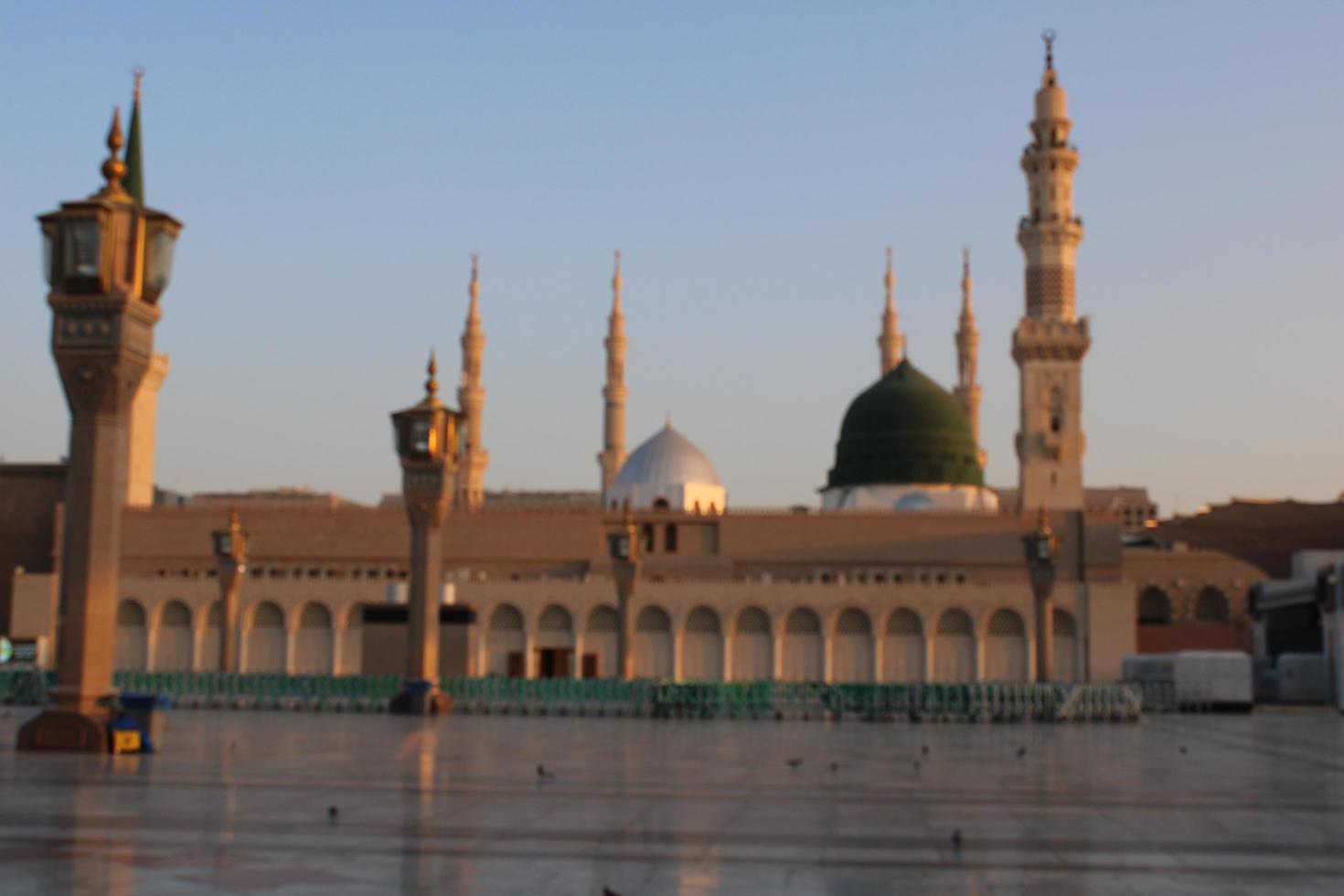 Medina, Saudi Arabia, Oct 2022 - Beautiful daytime view of Masjid Al Nabawi, Medina's green dome, minarets and mosque courtyard. photo