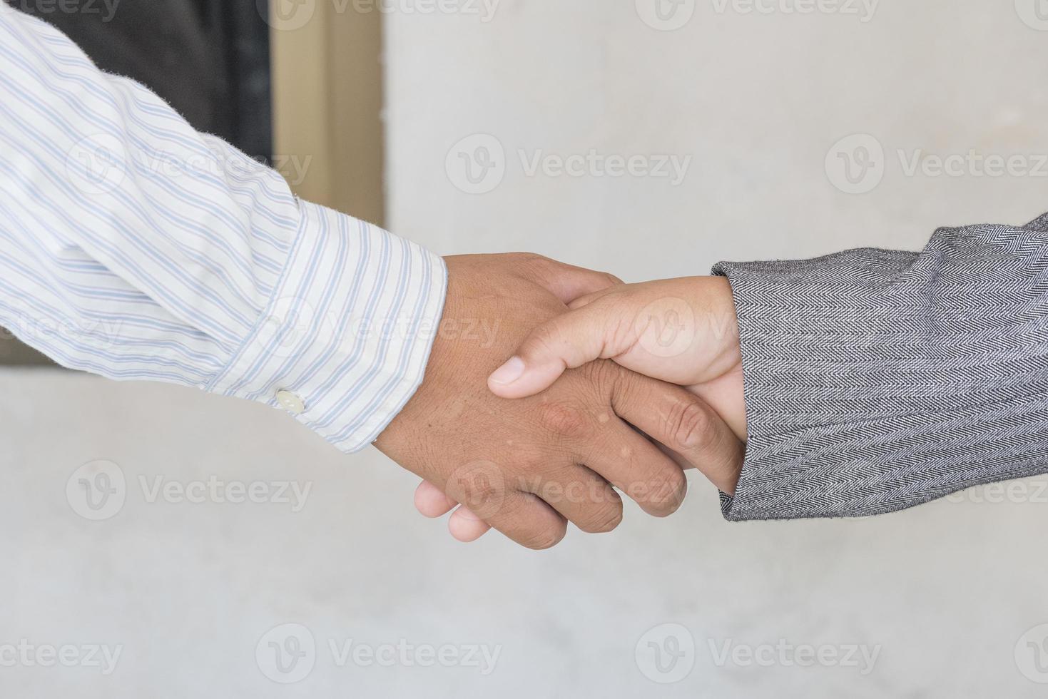 Two confident business man shaking hands . photo