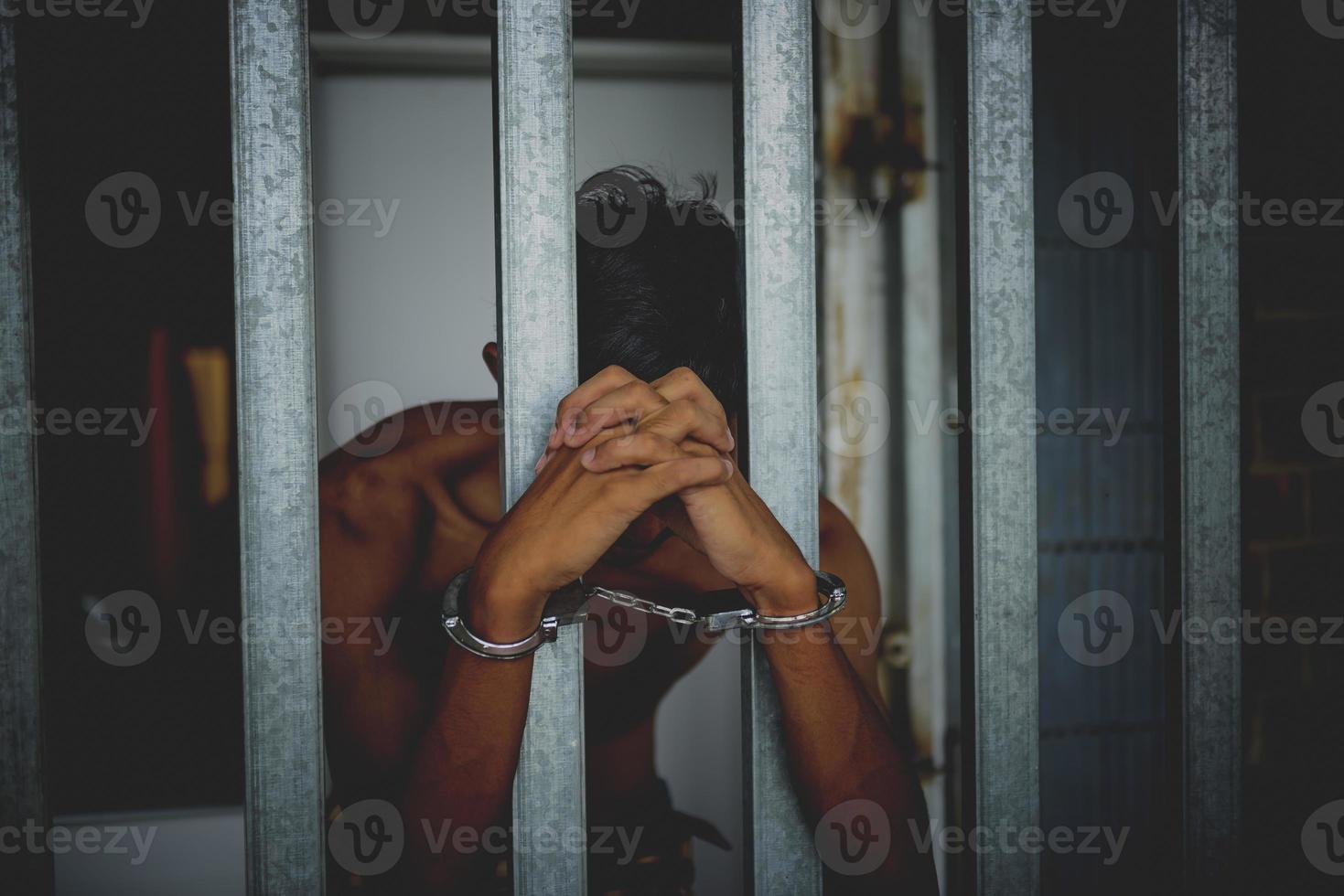 Hand of the prisoner on a steel lattice close up photo