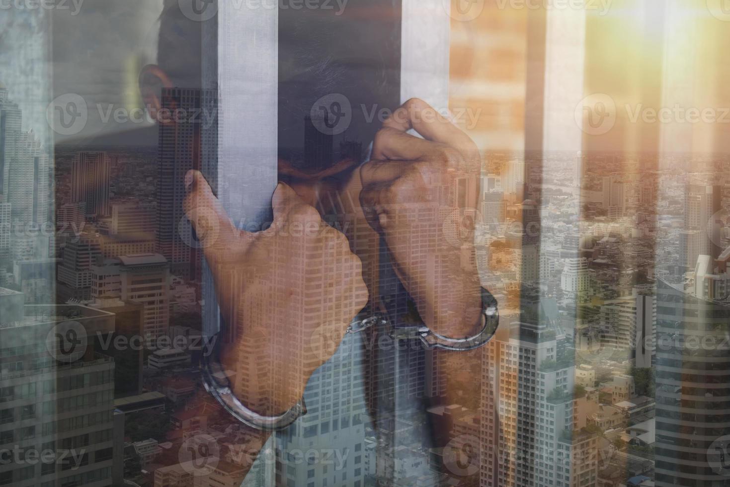 Hand of the prisoner on a steel lattice close up photo