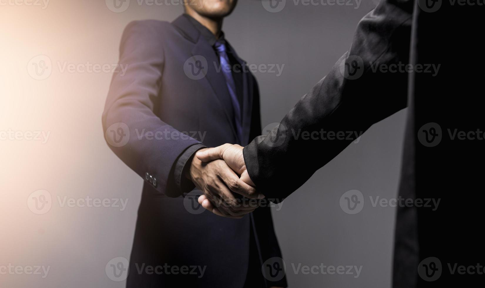 Two confident businessman shook hands during office meetings. photo