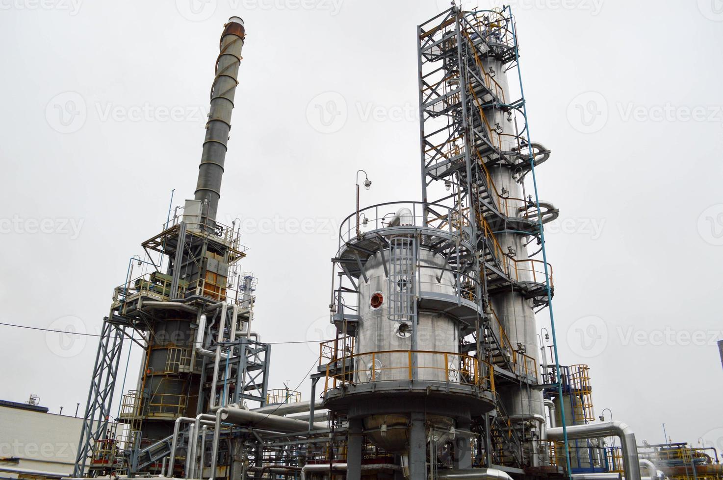 Rectification column, large metal container, furnace at the oil refinery. Equipment for petrochemical production. photo