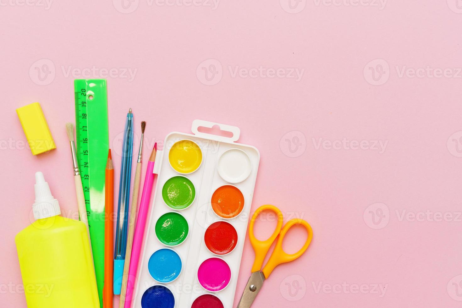 School supplies, colored pencils, watercolor paints, pens, ruler and scissors photo