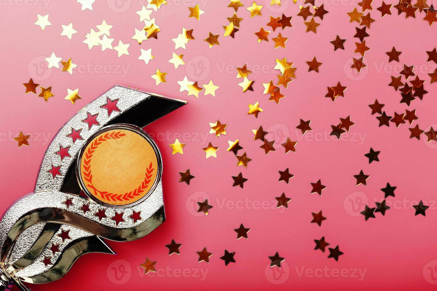 Superprize of gold with fireworks of stars on a red background. photo