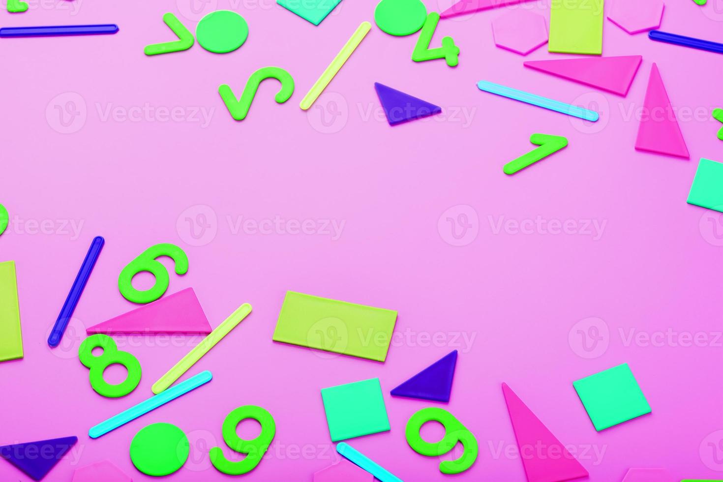 Colorful figures and numbers for children on a pink background. A tool for developing children's thinking. photo