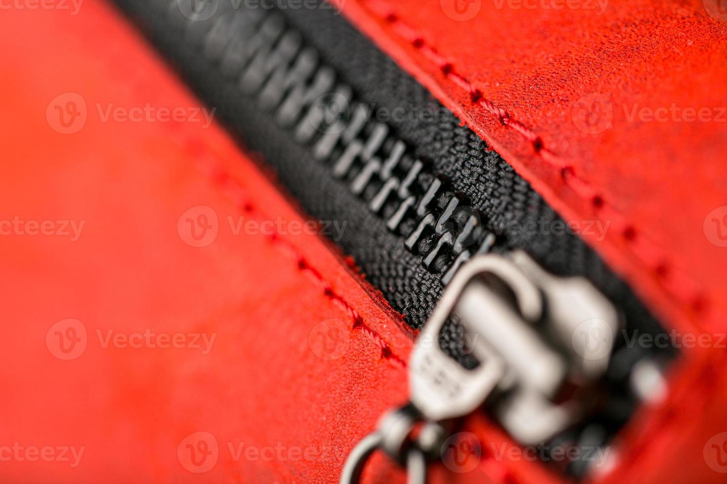 Zipper slider for a red suede leather bag. photo