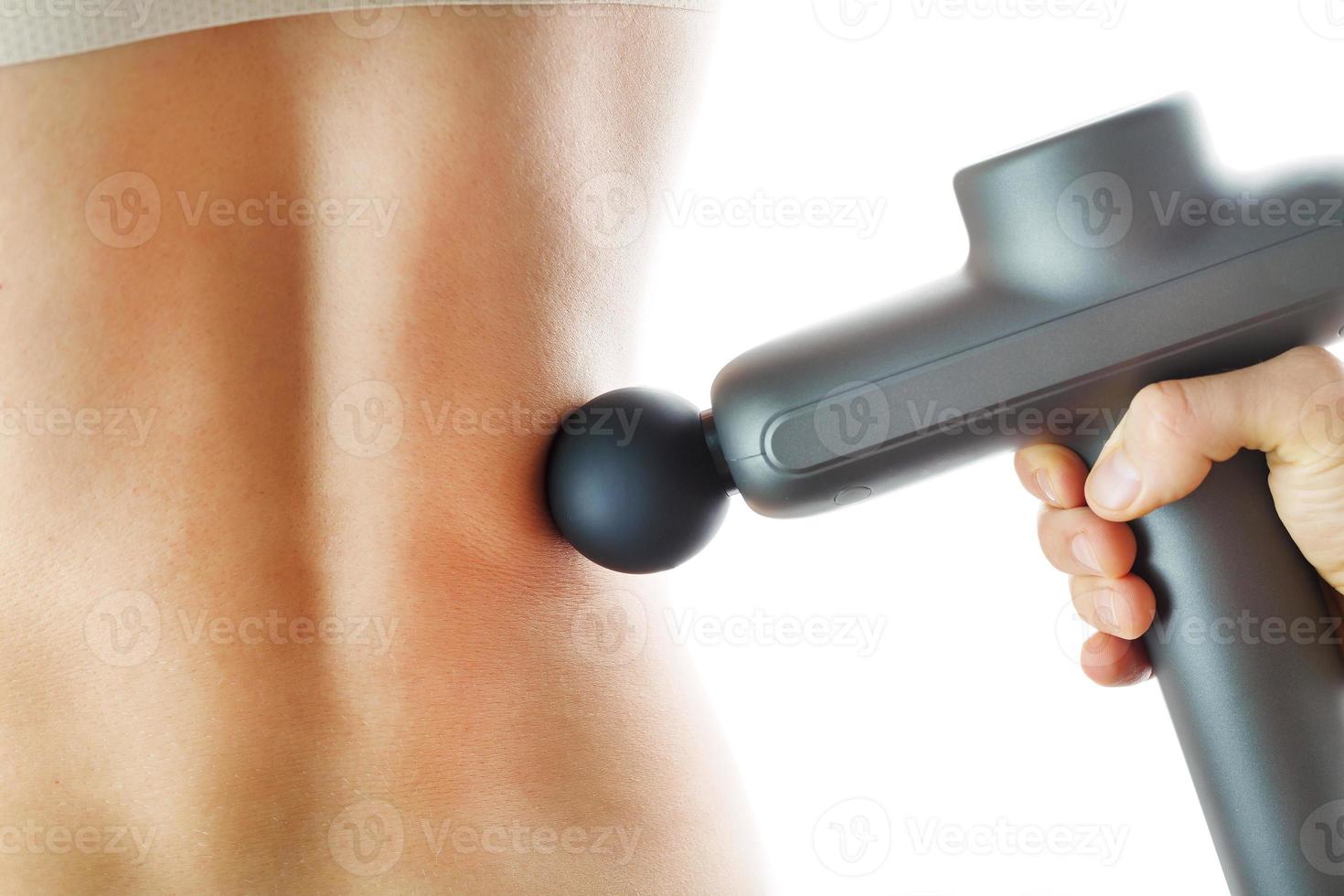 Back massage with an Electric body massager. photo