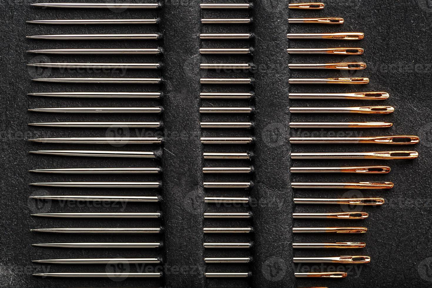 A set of sewing needles on a black background. photo