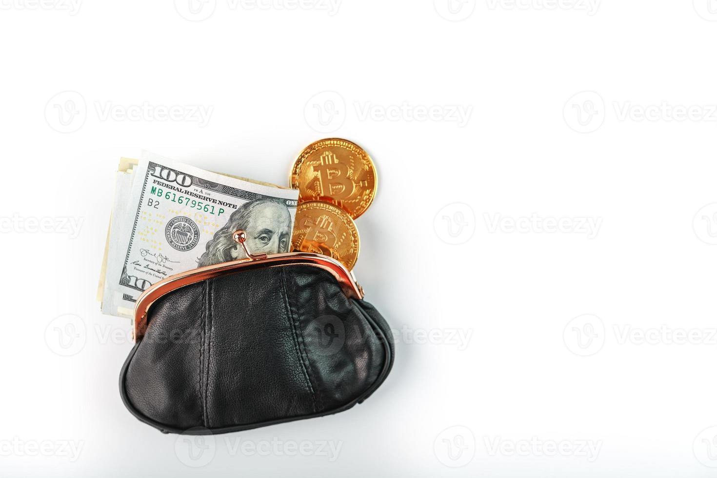 An open black wallet with money, dollars and bitcoin coins on a white background. photo