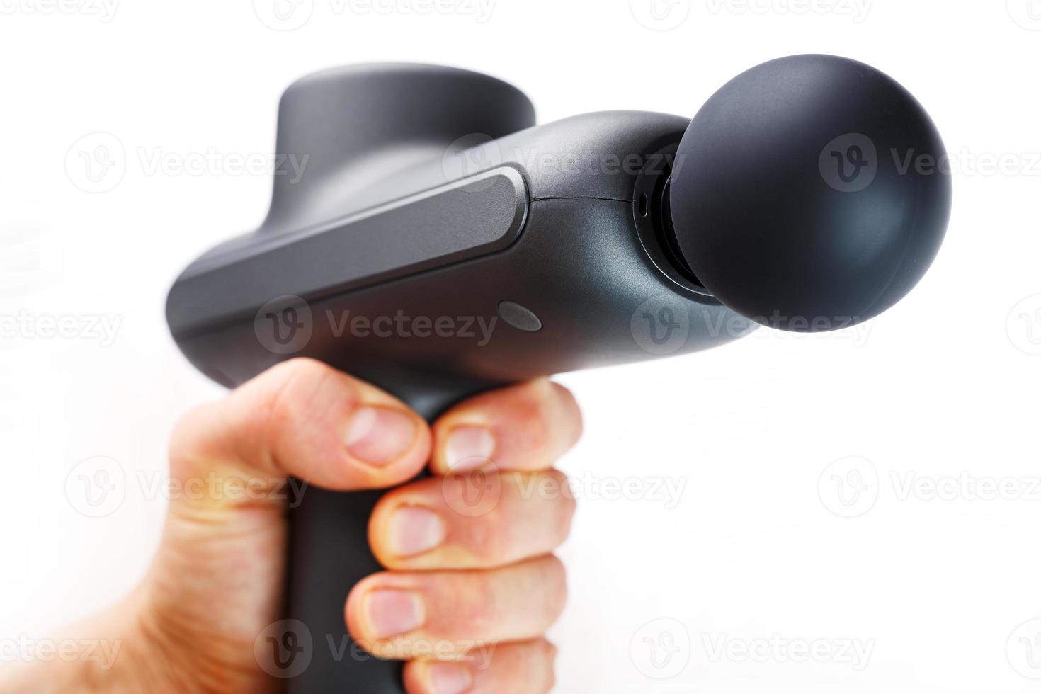 Manual electric body massager in hand on a white background. photo