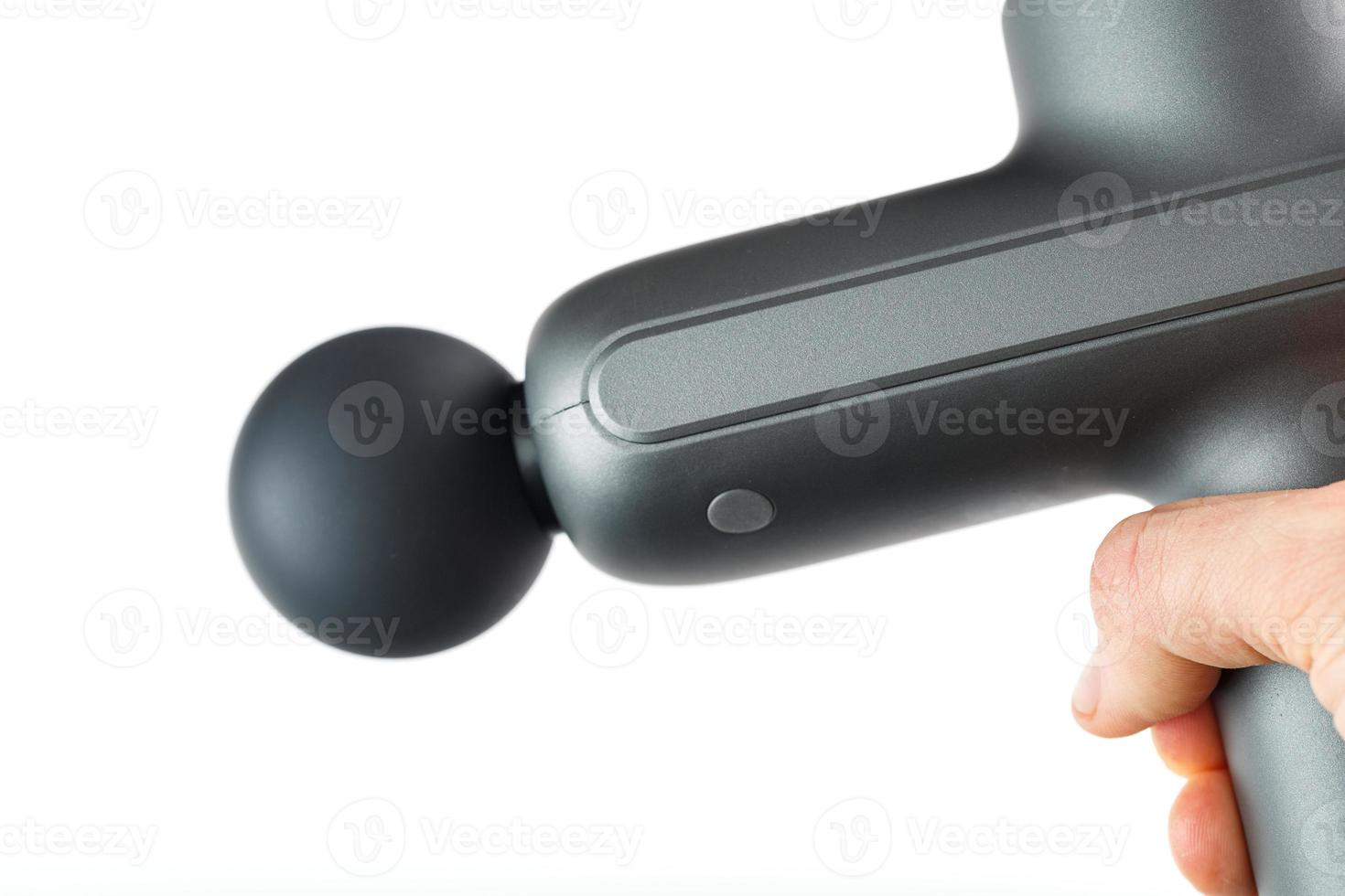 Manual electric body massager in hand on a white background. photo