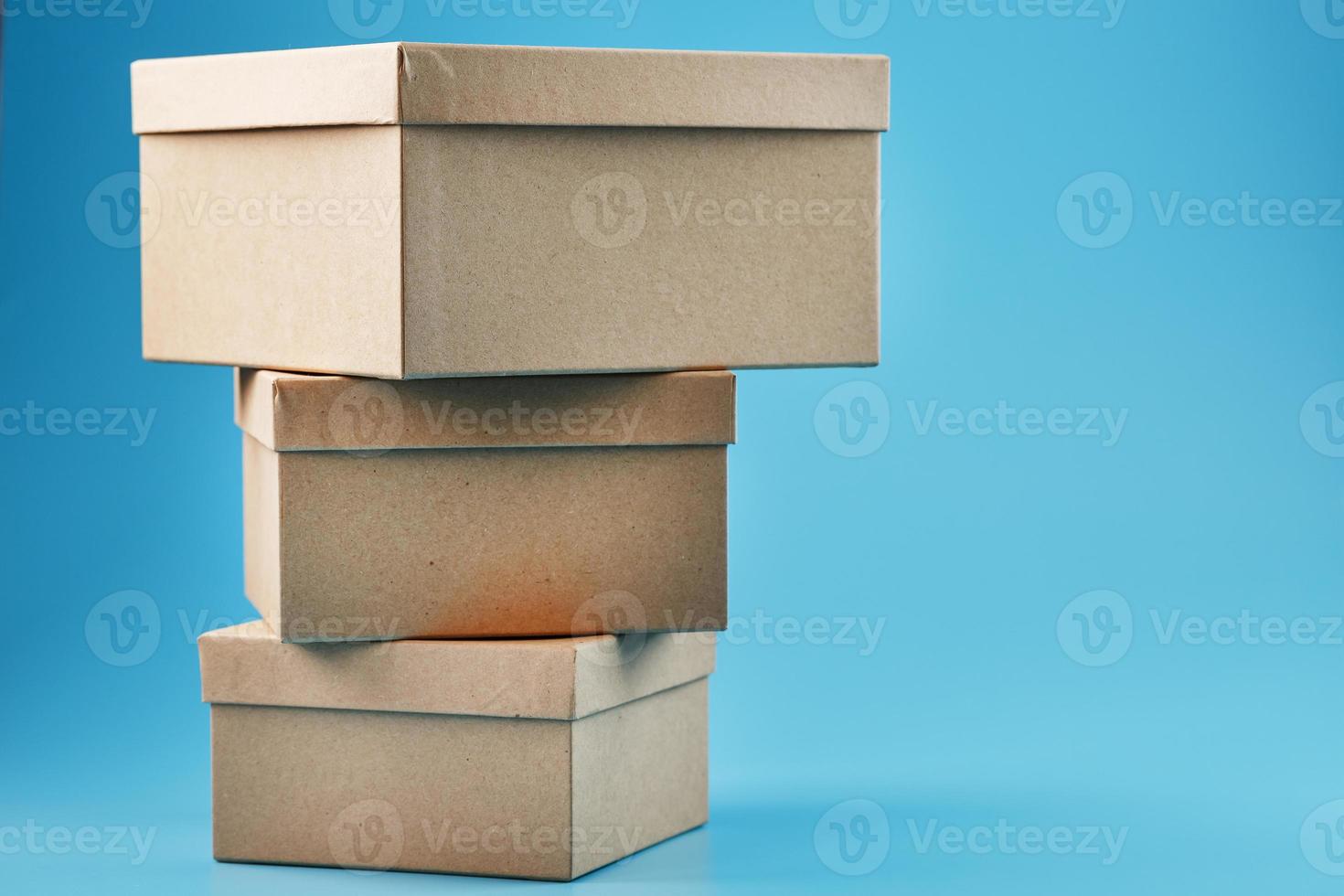 Cardboard boxes in the shape of a pyramid on a blue background. photo