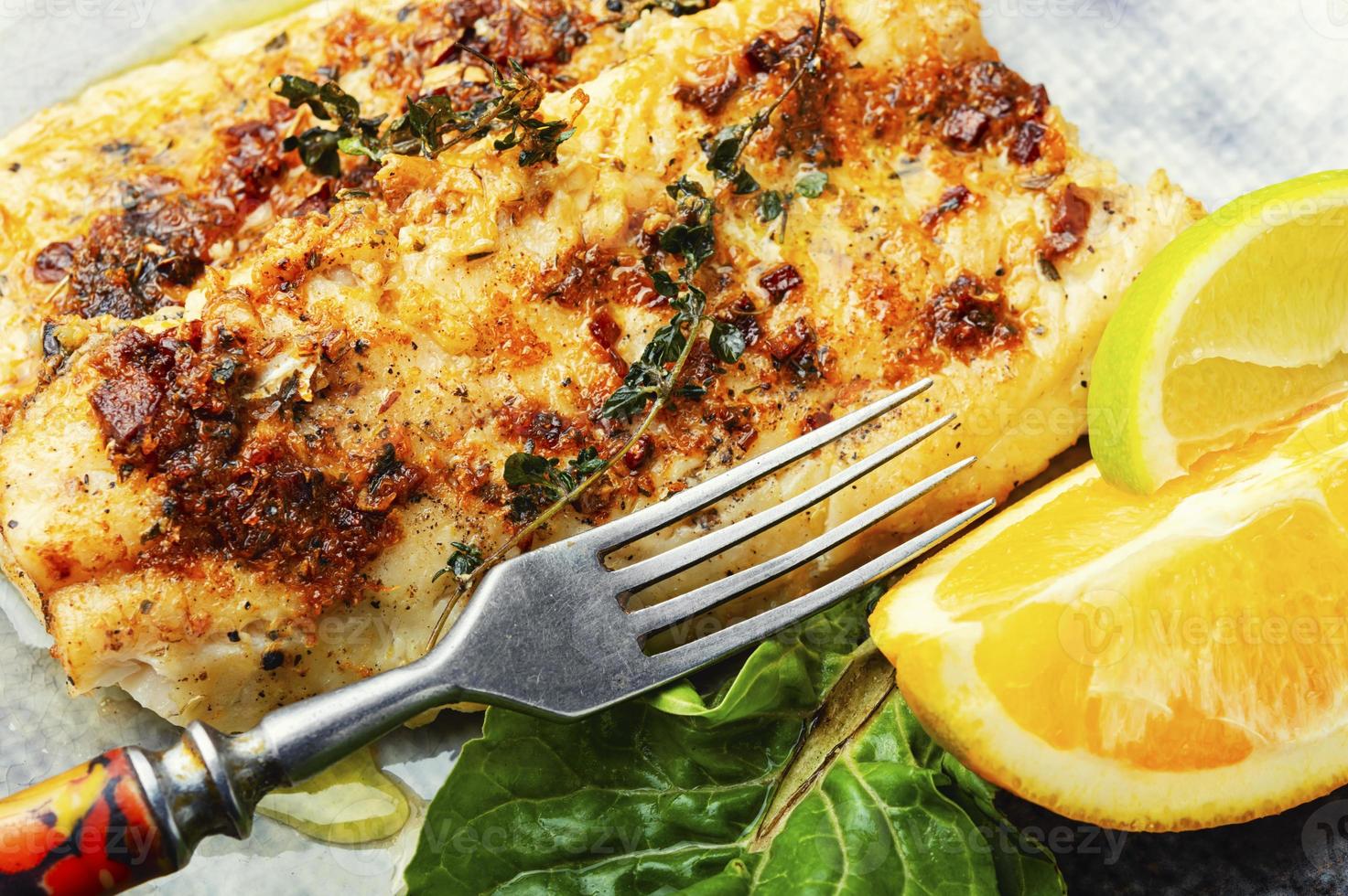 Fried fish fillets in orange oil. photo