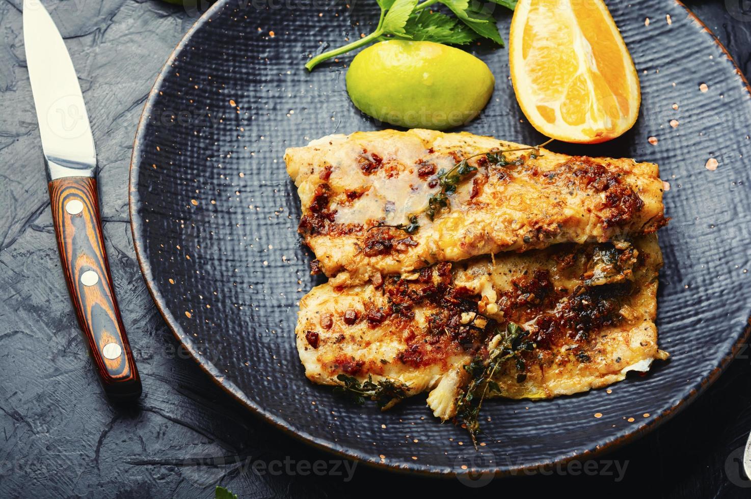 Fried fish fillets in orange oil. photo