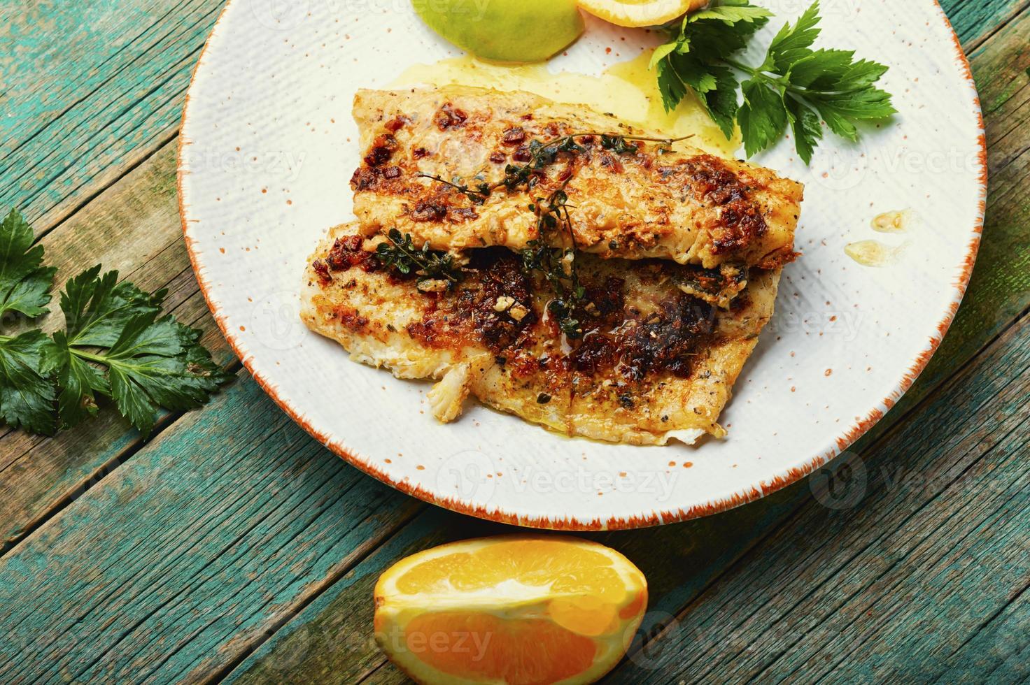 Fried fish fillets in orange oil. photo