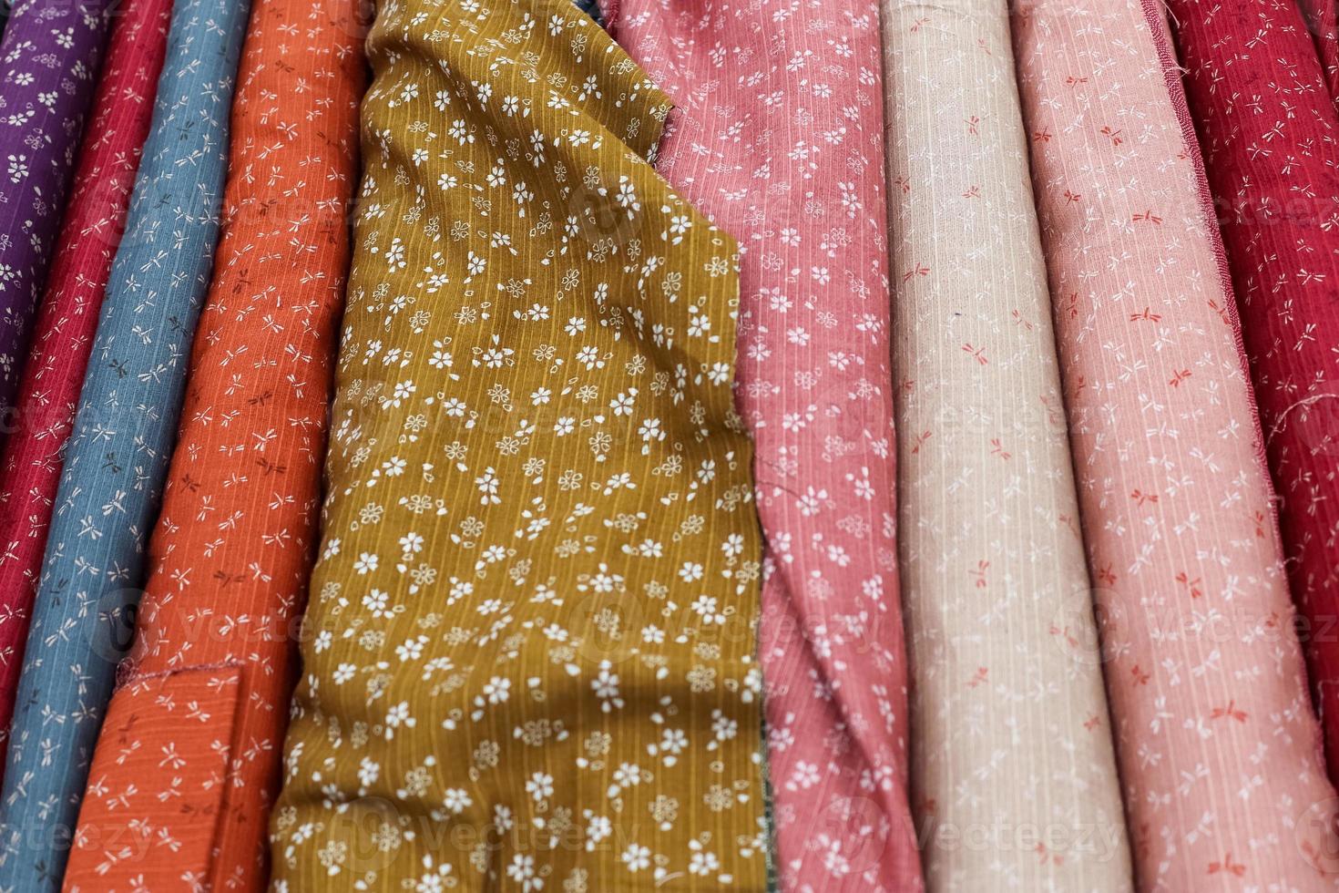 Samples of cloth and fabrics in different colors found at a fabrics market photo