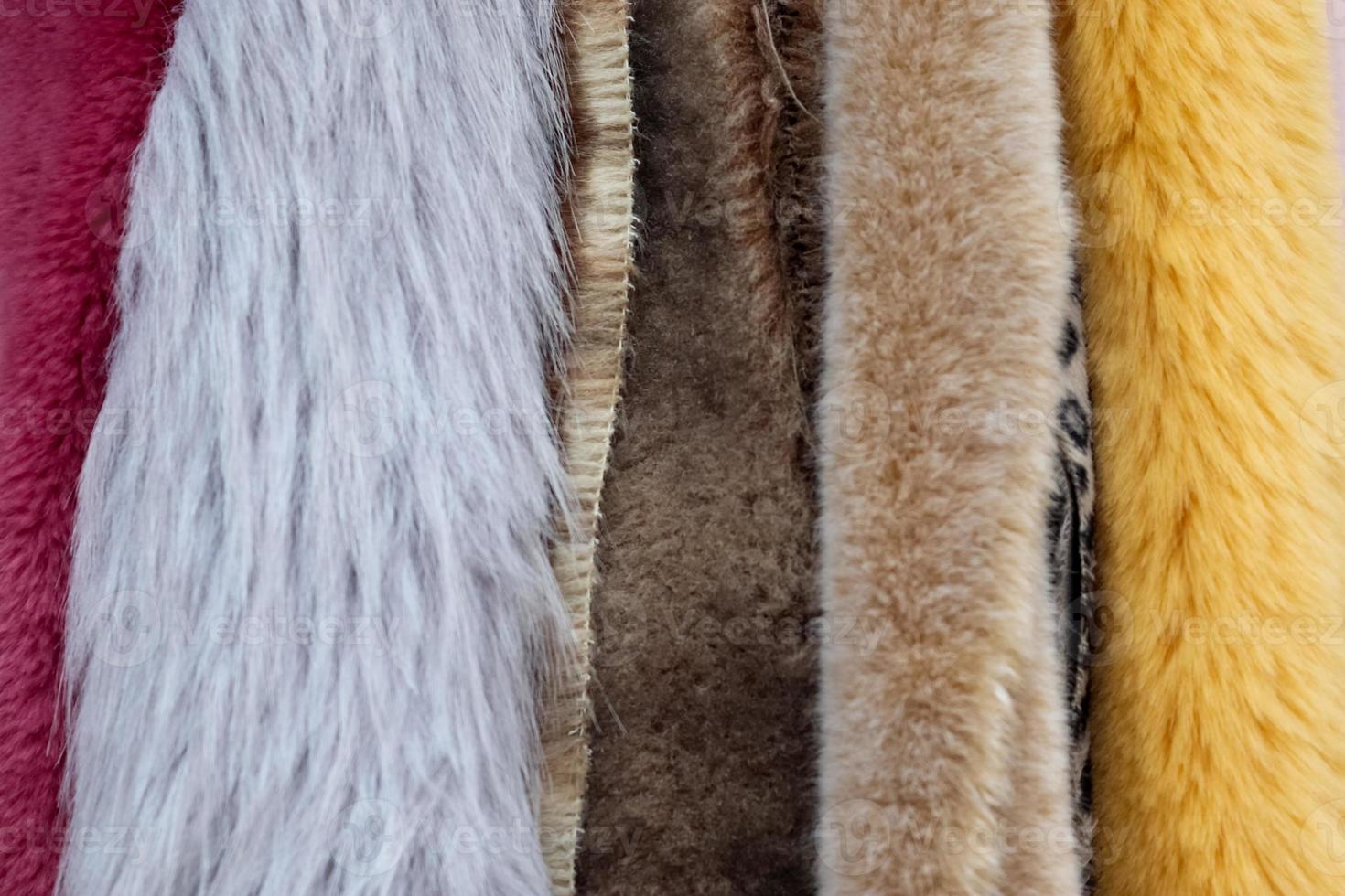 Samples of cloth and fabrics in different colors found at a fabrics market photo