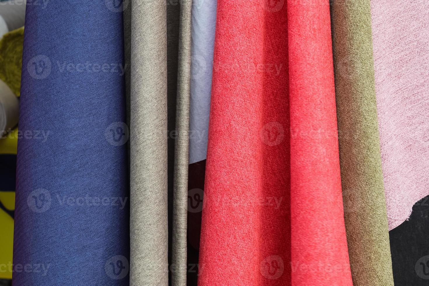 Samples of cloth and fabrics in different colors found at a fabrics market photo