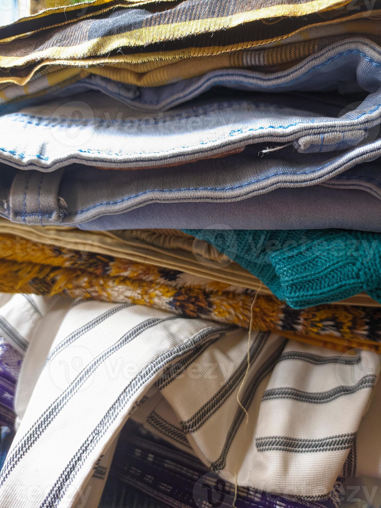 piles of various wears and pants after ironing. a neatly arranged pile