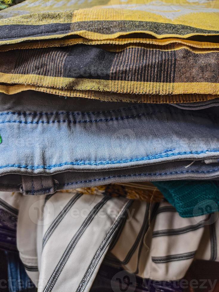 a neatly arranged pile of various neat clothes and pants after ironing. photo