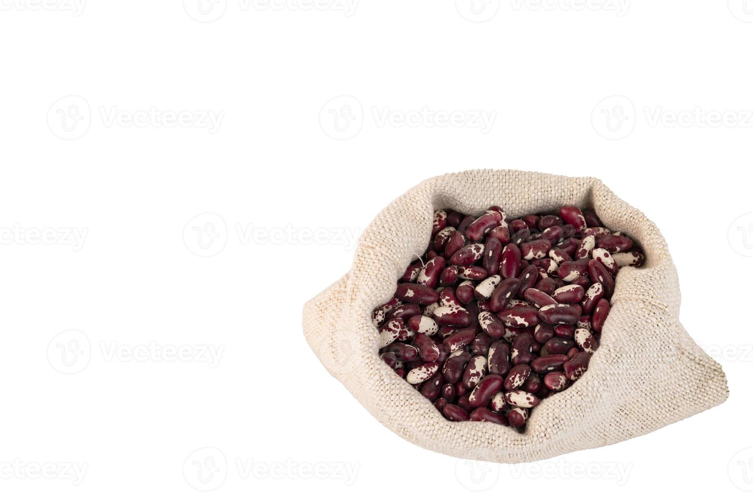 Colored beans, red and white bean seeds in a linen bag, White isolated background. photo