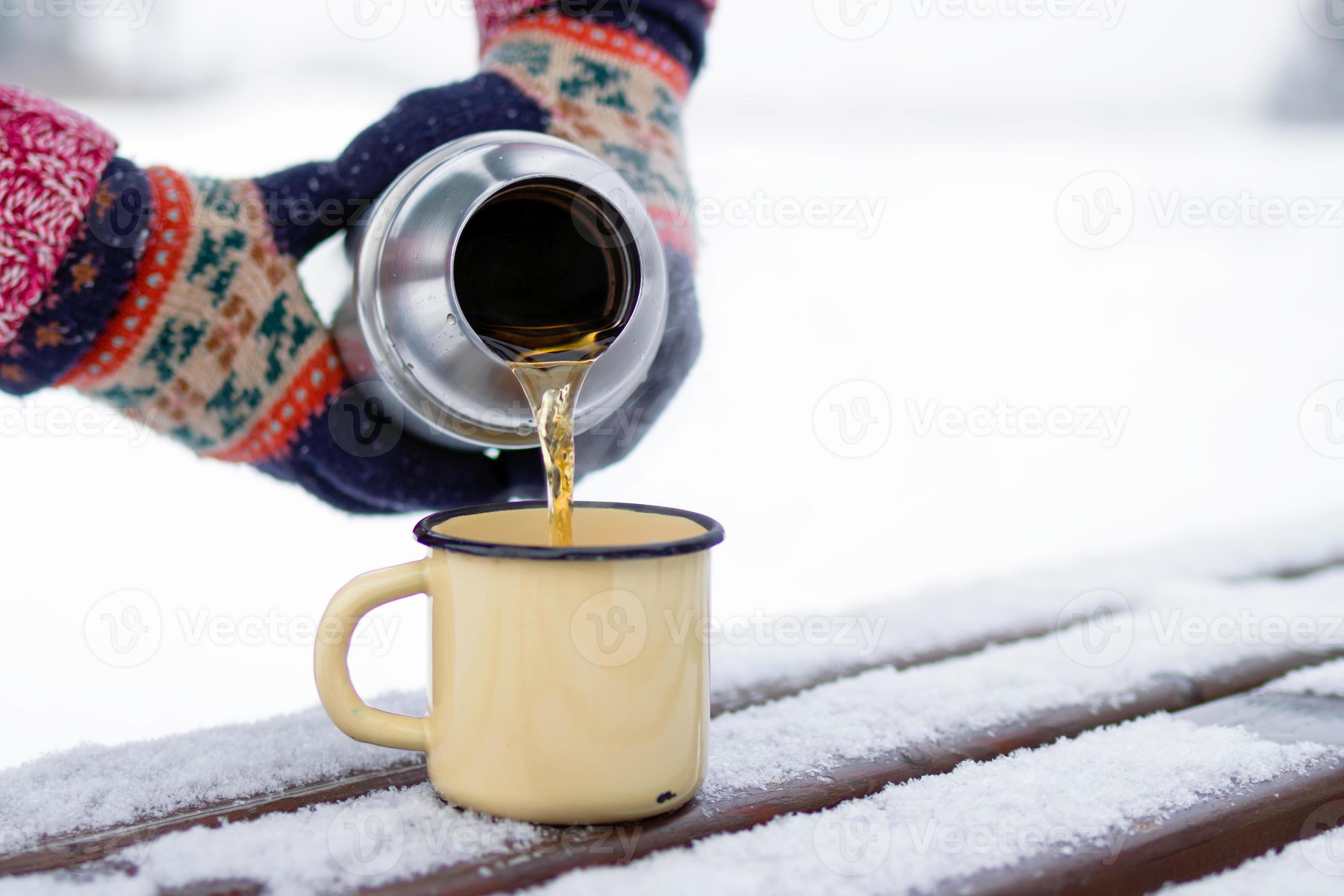 Close-up of Man Holding Thermos and an Iron Mug, Pouring Hot Tea