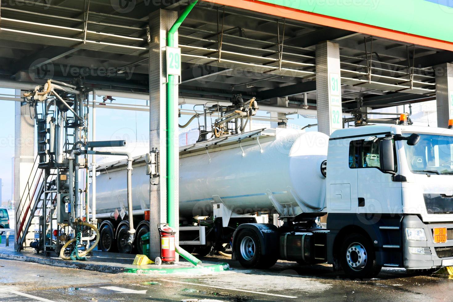 Large green industrial gas station for refueling vehicles, trucks and tanks with fuel, gasoline and diesel in the winter photo