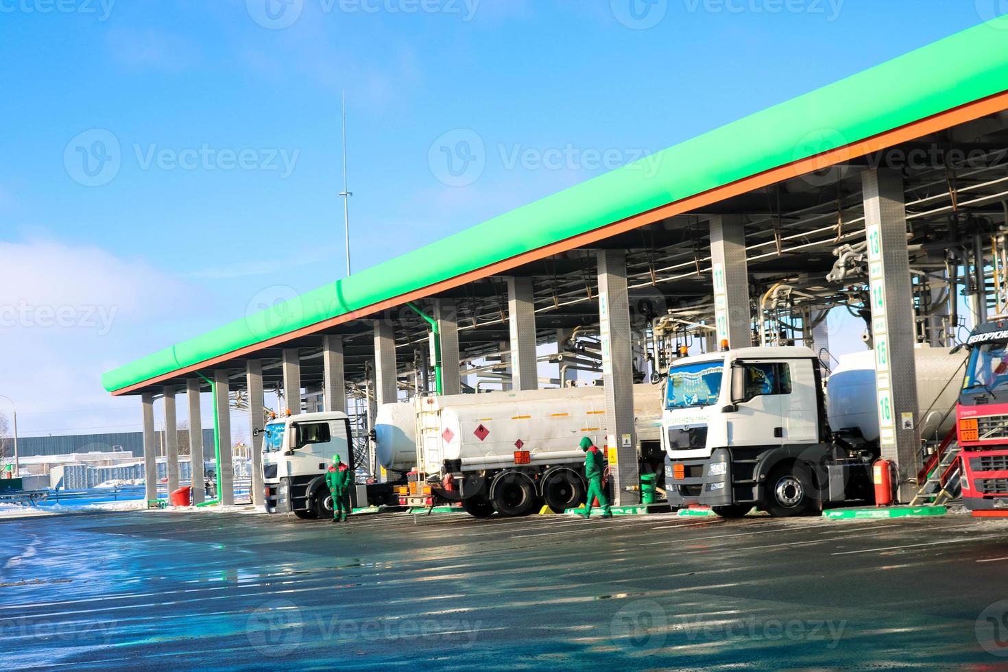 Large green industrial gas station for refueling vehicles, trucks and tanks with fuel, gasoline and diesel in the winter photo