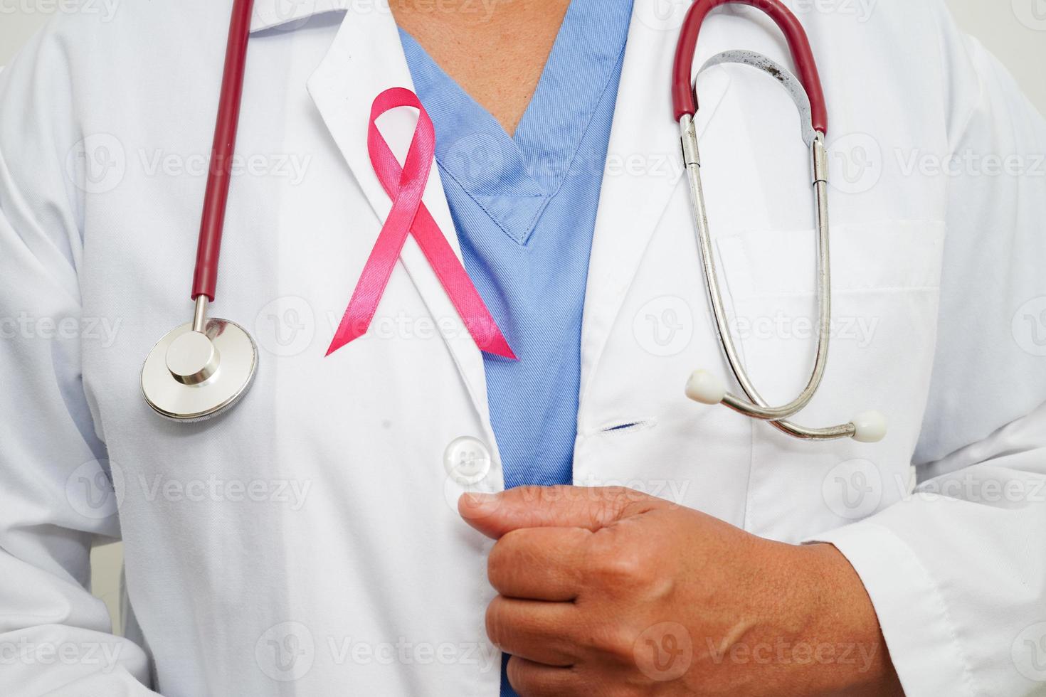 Asian woman doctor with pink ribbon, World Breast Cancer Day at October. photo