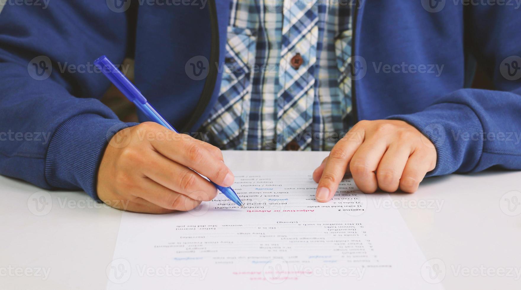 hand holding blue pen photo