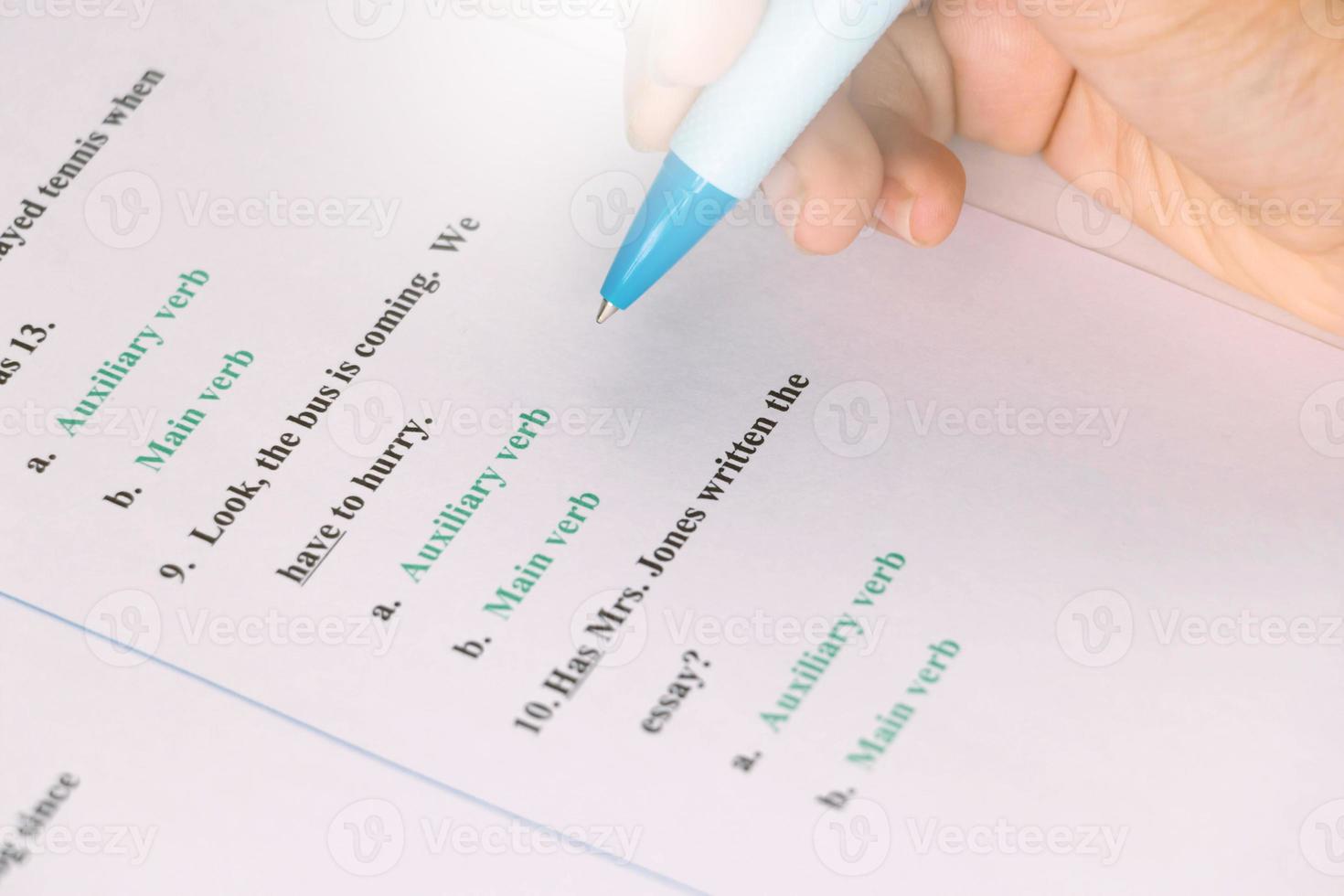 student's hand taking English test in class photo