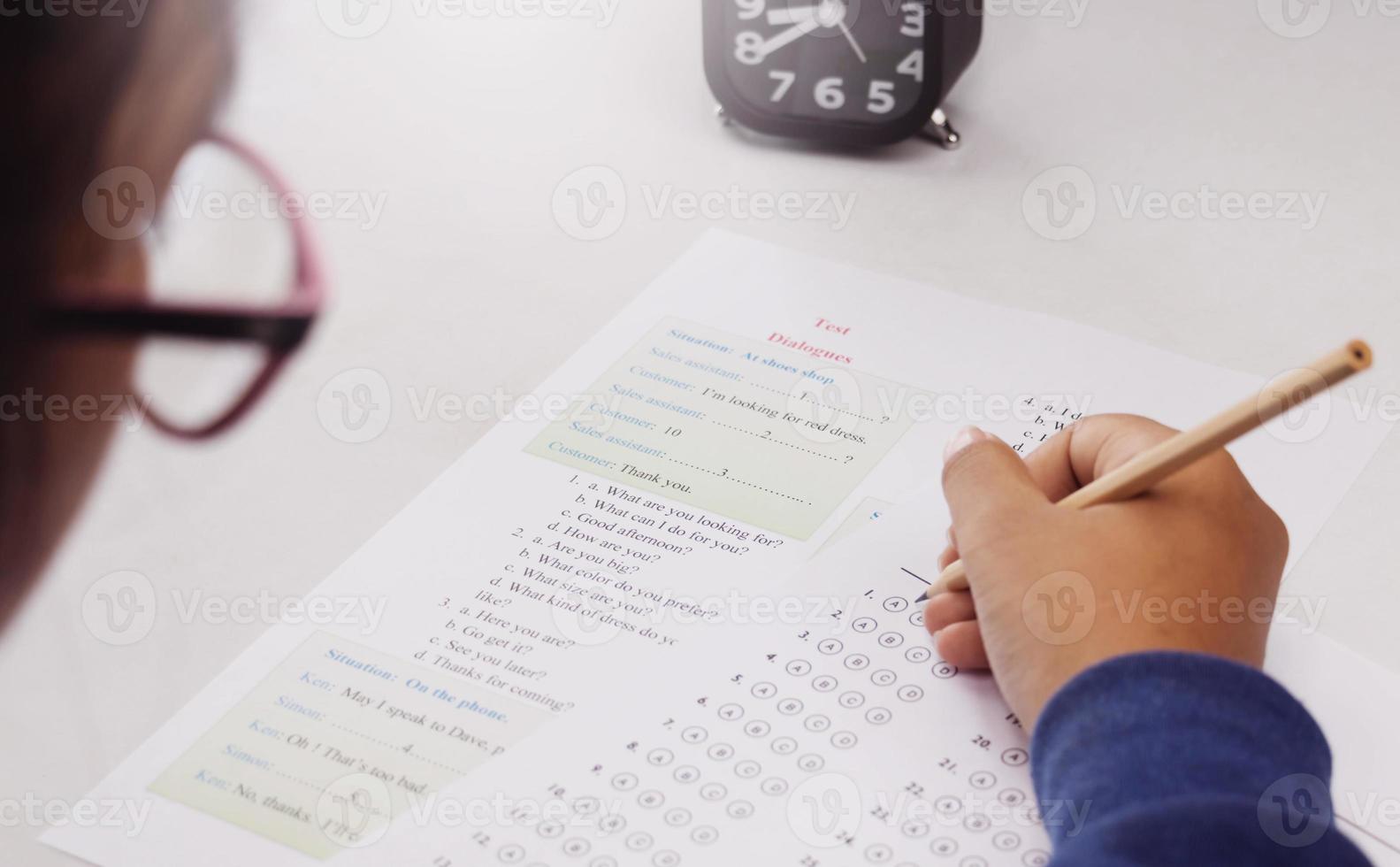 student's hand taking English test in class photo