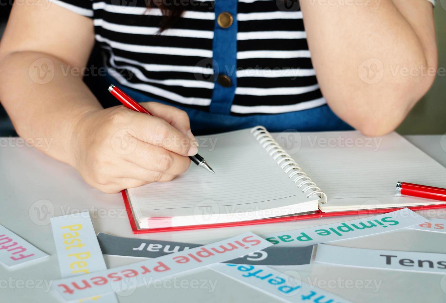 mano de mujer escribiendo con tarjetas tensas foto