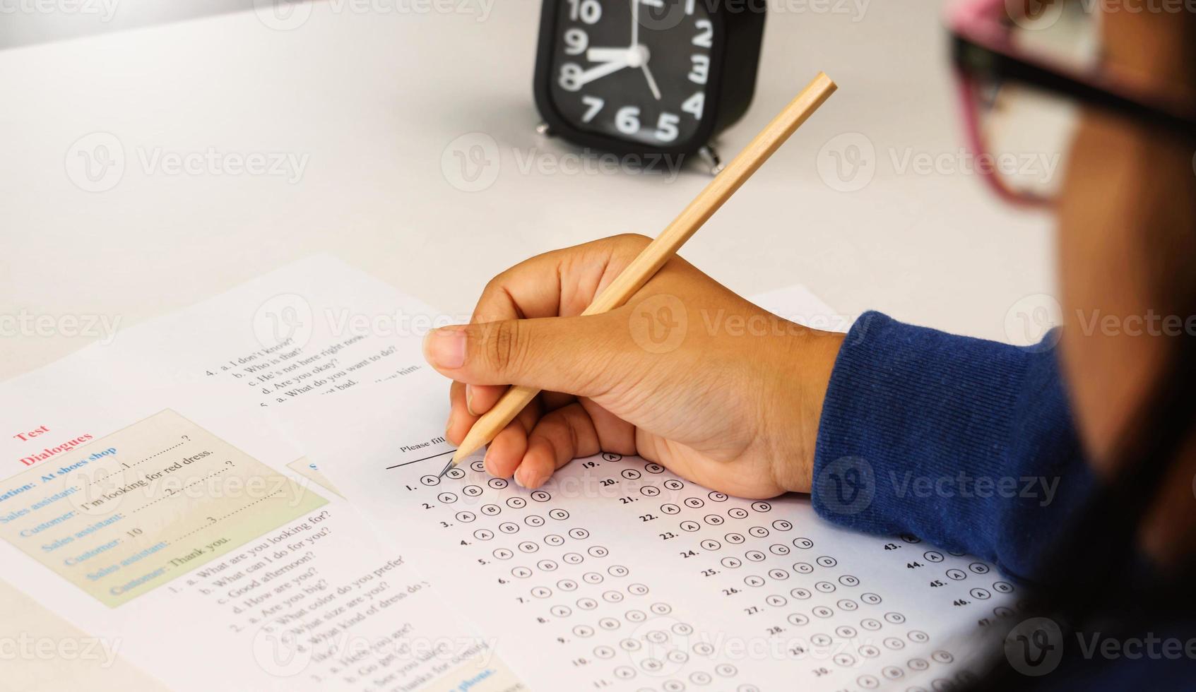 student's hand taking English test in class photo