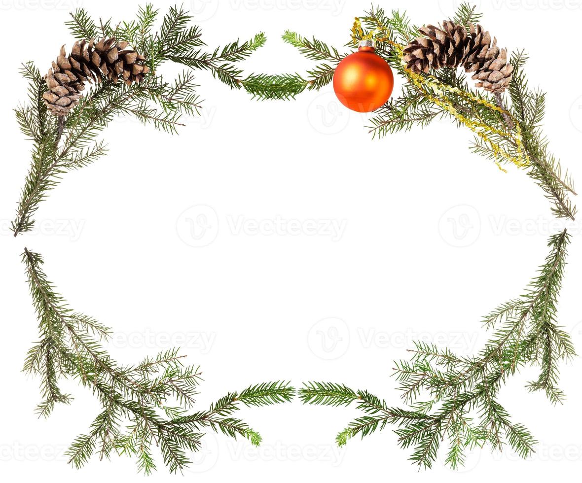 spruce tree branches with cones and orange ball photo
